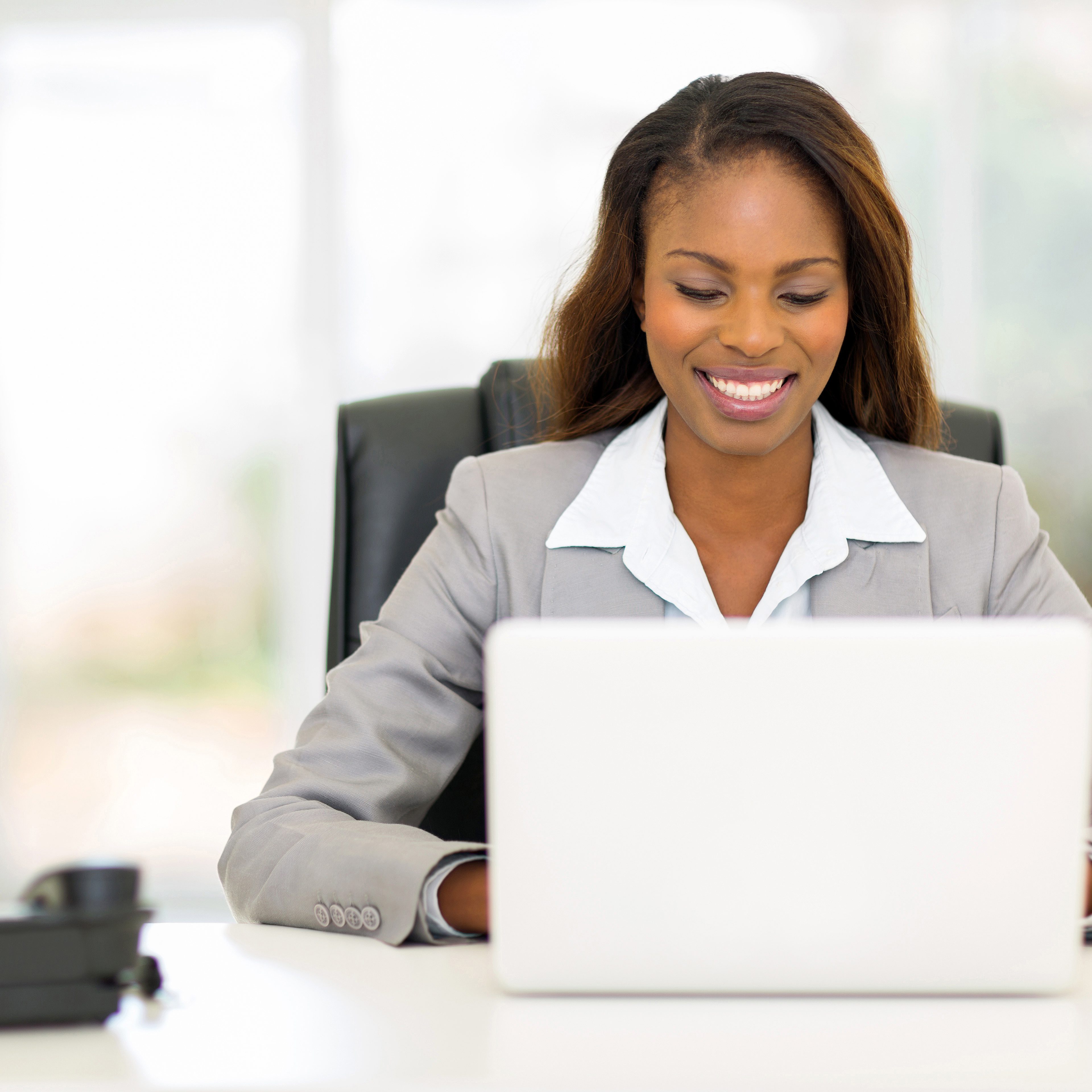 pretty afro american businesswoman using laptop computer