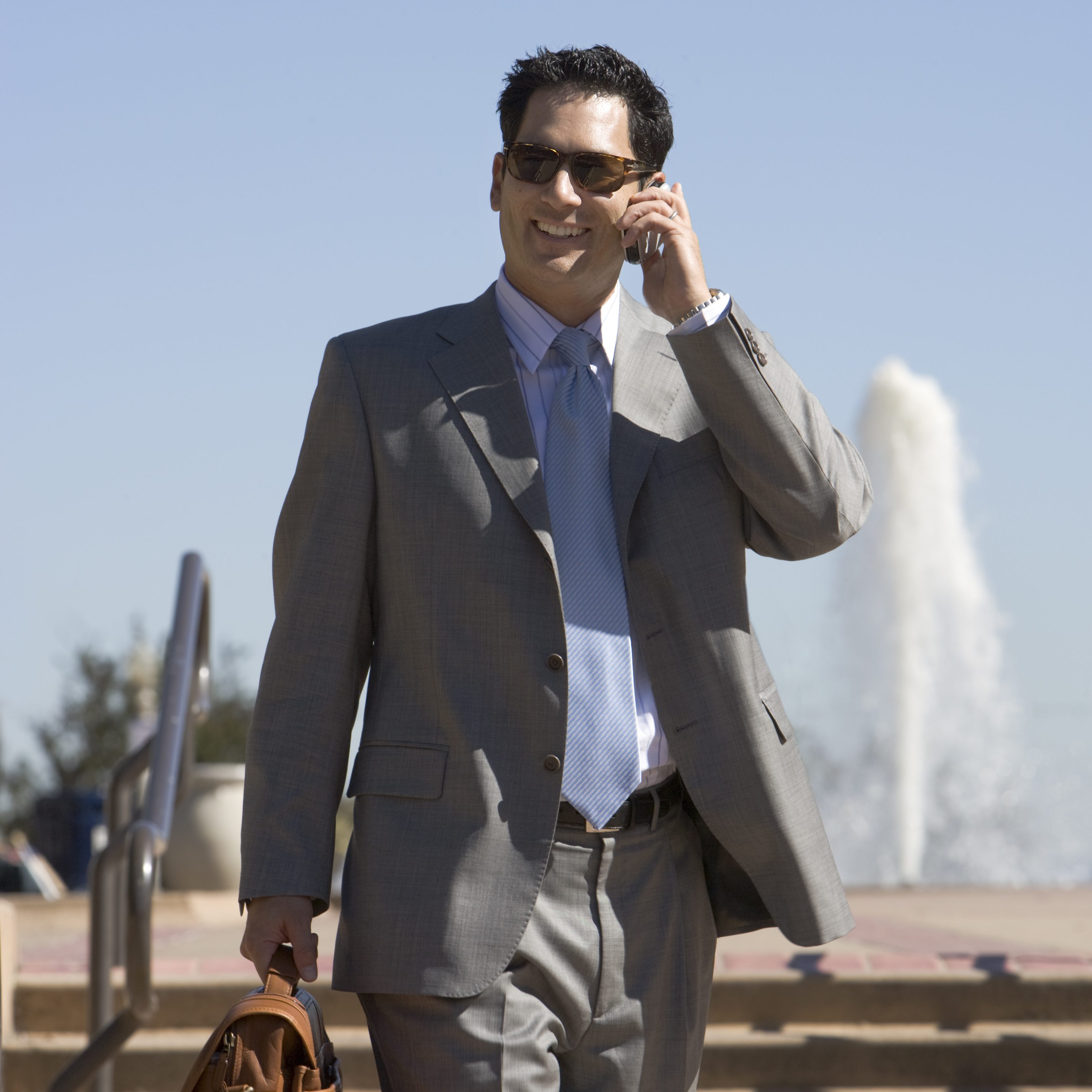 Businessman talking on cell phone outdoors