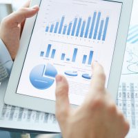 Market analysis in touchpad and hand of businessman explaining it